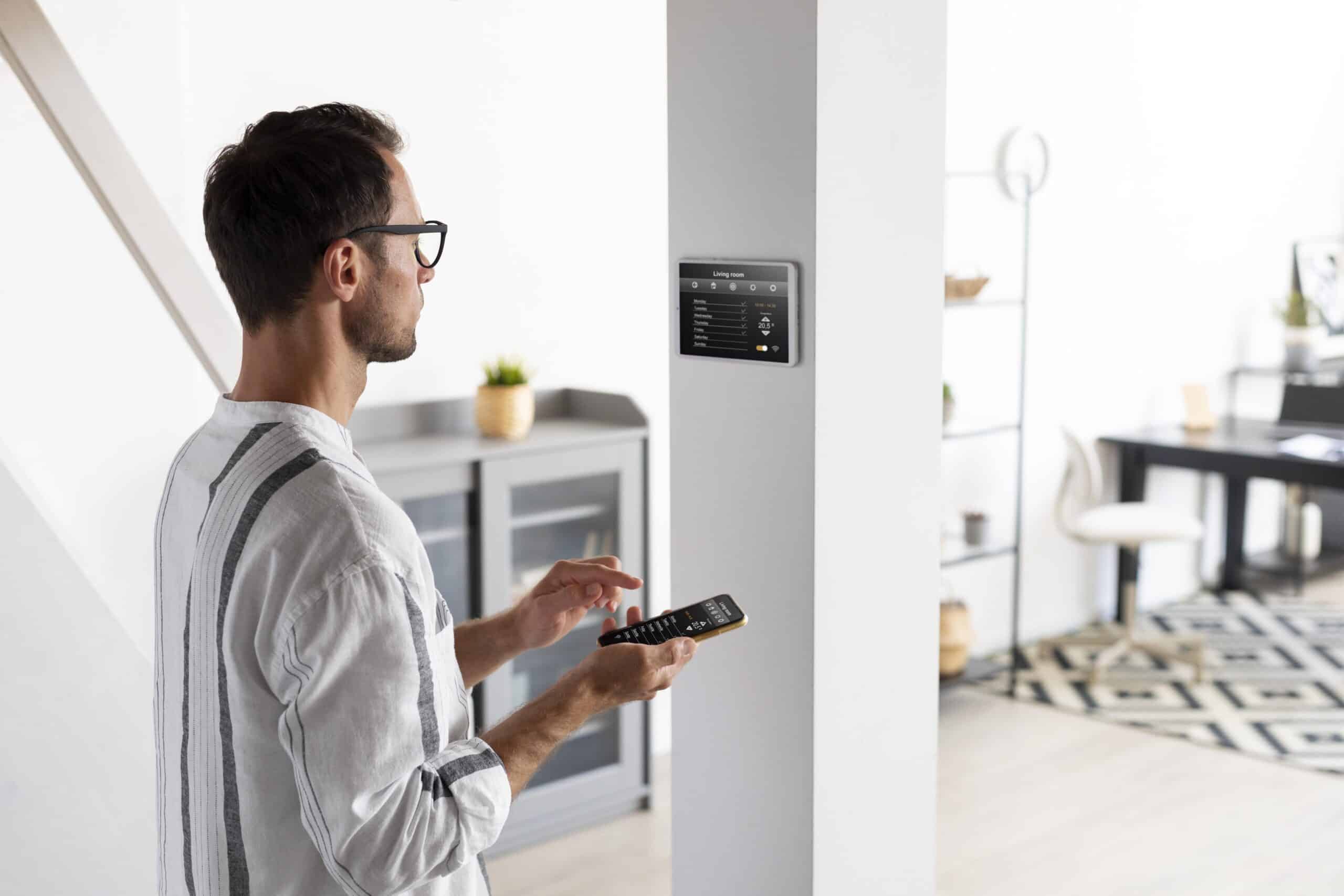 person using smartphone his automated home scaled