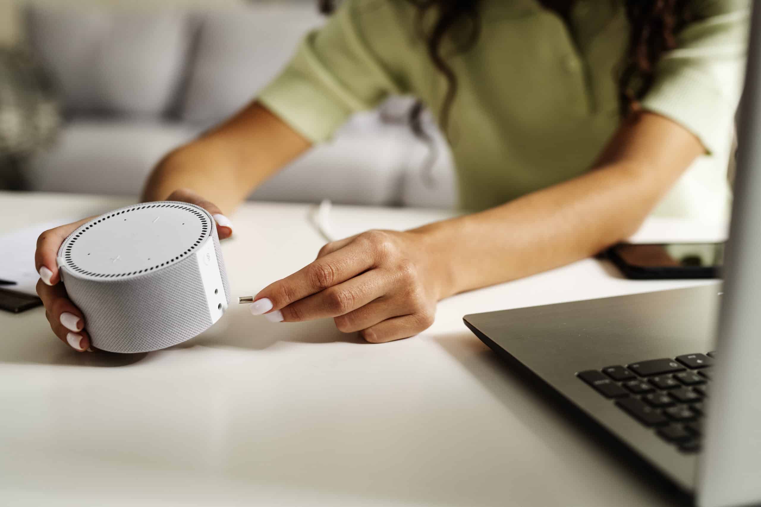 woman holding smart speaker side view scaled